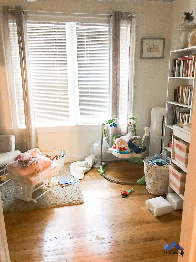 a living room filled with furniture and a window